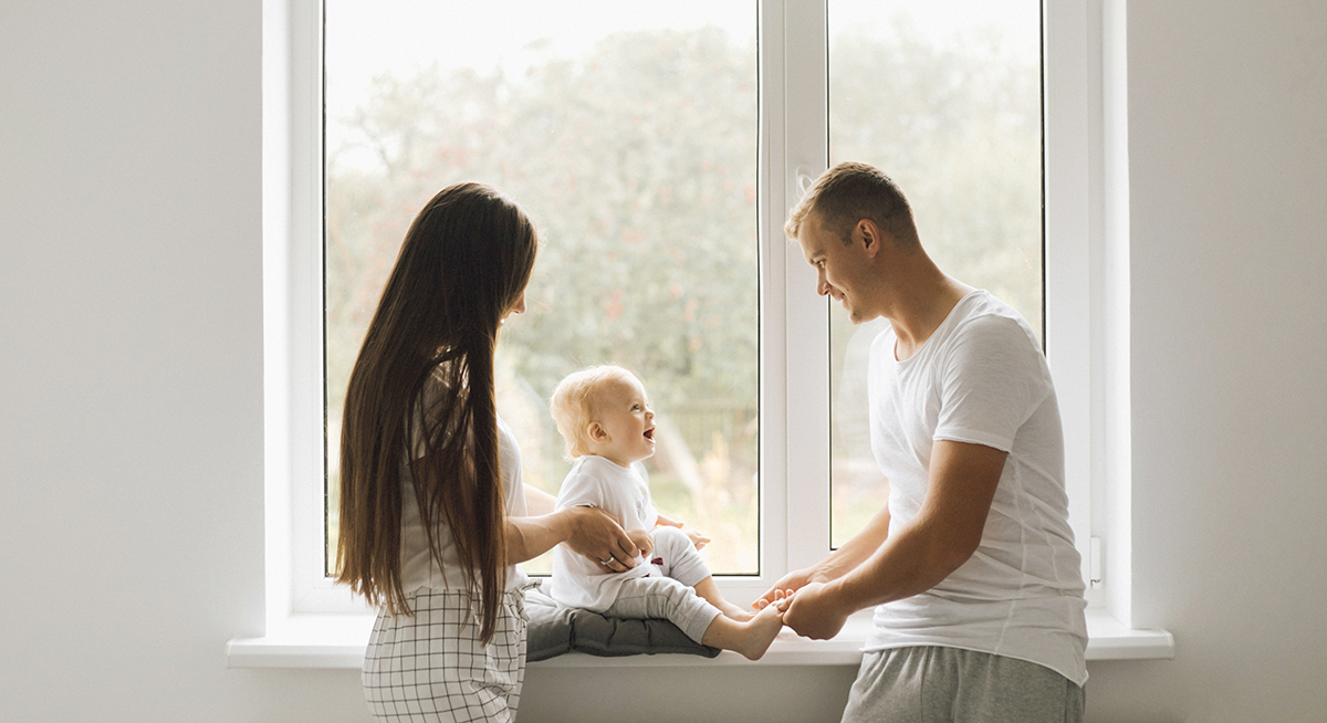 Mom and dad play with their little son